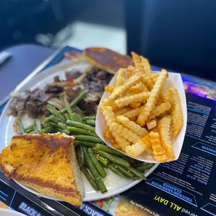 Steak tips with green beans , fries and garlic toast