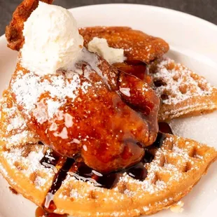 a waffle topped with ice cream and syrup