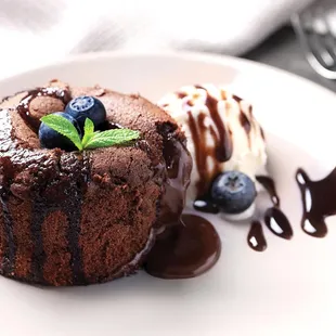 a chocolate dessert with ice cream and blueberries