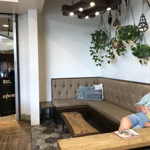 a man sitting on a couch in a coffee shop
