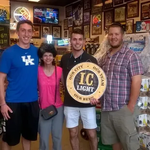 three men and a woman posing for a picture