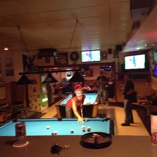 a pool table and tvs