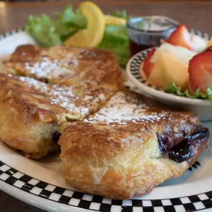 a plate of pastries and a bowl of fruit