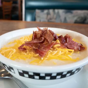 a bowl of soup with bacon and cheese