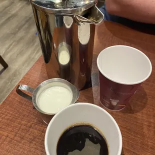 a cup of coffee and a coffee pot