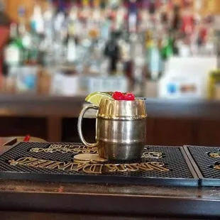 a metal mug on a bar