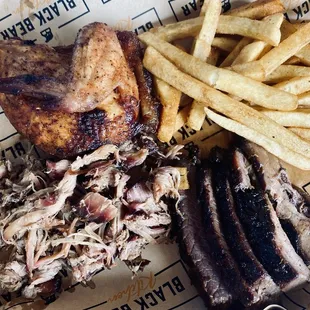 Three meat plate with chicken, brisket and pulled pork ( he added the seasoned fries)