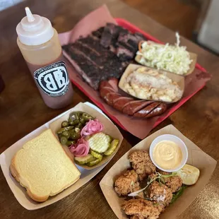 Black Board Bar B Q garlic confit sausage, mac-and-cheese, ribs, brisket, creamy jalapeno slaw, quail lollipops, and BBQ sauce