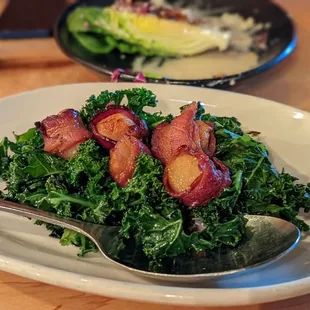 Bacon-wrapped scallops on a bed of kale