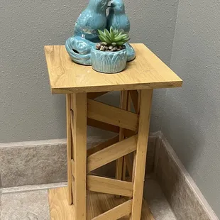 a blue bird on top of a wooden table