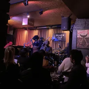 a band playing on stage at a bar