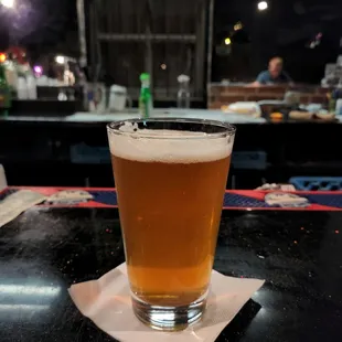 a glass of beer on a table