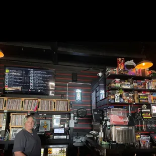 a man standing in front of a bar