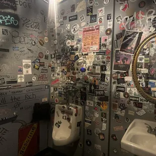 Unisex bathrooms covered in stickers