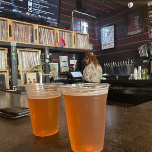 two cups of beer on a bar counter