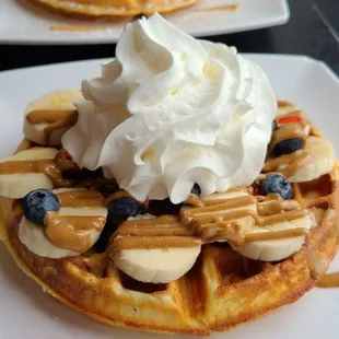 two waffles with whipped cream on top