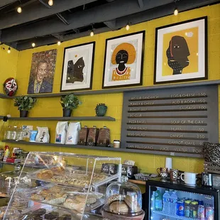 a yellow brick wall and a display of pastries