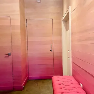 a pink bench in a hallway
