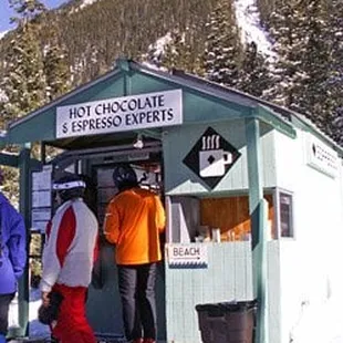 a group of skiers at a hot chocolate stand