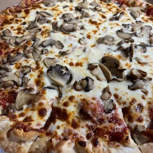 a pizza with mushrooms and cheese