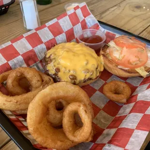 Burger with baked beans and cheese and onion rings