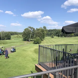 View of golf course from patio and tables.