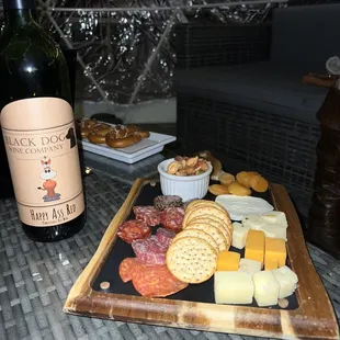 Wine, frozen pretzels and cheese tray.