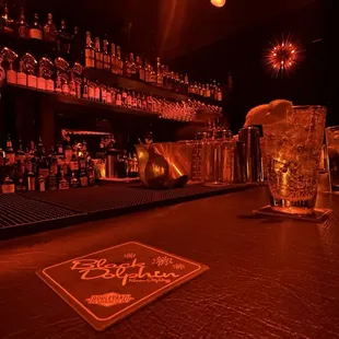 a bar with alcohol bottles and glasses