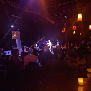 a group of people sitting in a dimly lit room