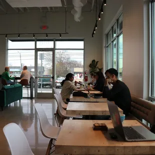  people sitting at tables with laptops