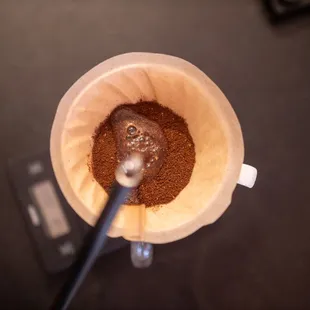 a coffee grinder filled with ground coffee