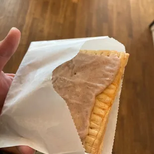 a hand holding a pastry