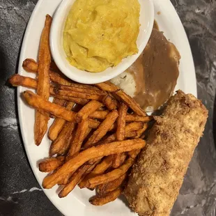 Veggie plate with squash, mashed potatoes and gravy, sweet potato fries and fried corn
