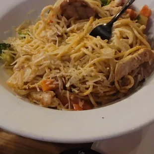 a plate of noodles with meat and vegetables