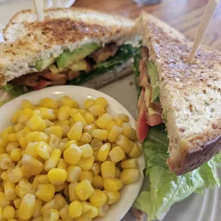 Bacon lettuce tomato and turkey with a side of corn.
