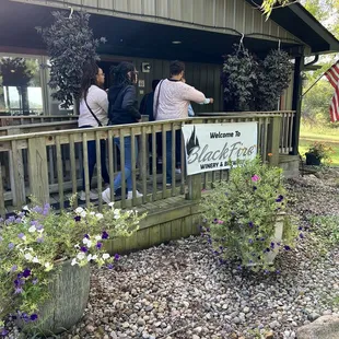 people standing on the porch of the winery