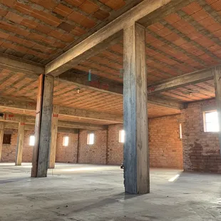 an empty room with exposed beams