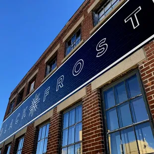 a brick building with a blue sign