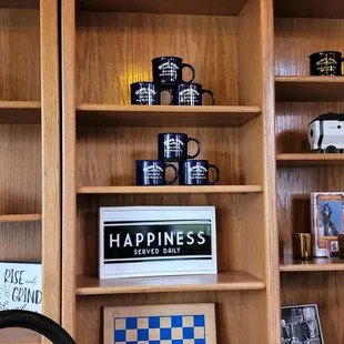 a shelf of coffee mugs