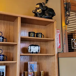 a shelf of coffee mugs