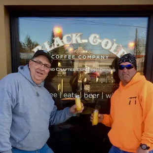 two men outside a coffee shop