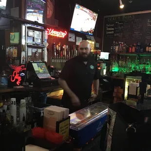 a man behind a bar counter