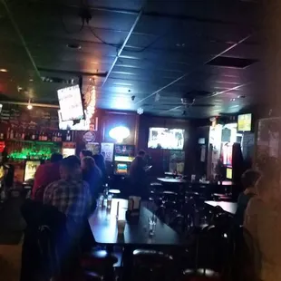 people sitting at tables in a bar