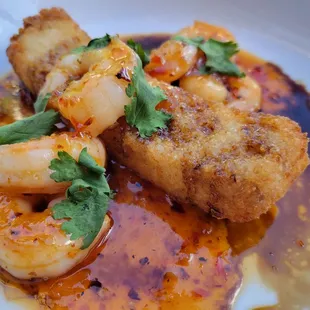 Thai chili shrimp, sour spicy glaze, crispy rice, cilantro, sesame seeds, and sweet soy sauce.
