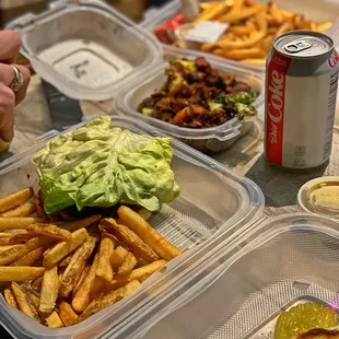 a sandwich, fries, and a can of soda