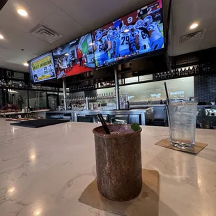 Lots of TVs and a massive and beautiful bar space. (Black N Mule is pictured)
