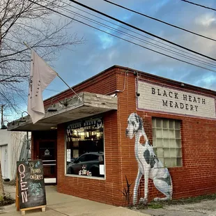 a brick building with a mural of a woman