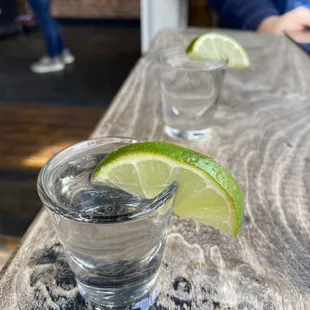 two glasses of water with lime wedges