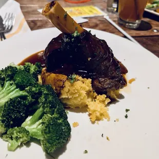 Lamb shank,  Y green beans in the background with the apple cider cranberry drink.