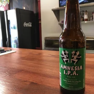 a bottle of beer on a wooden table